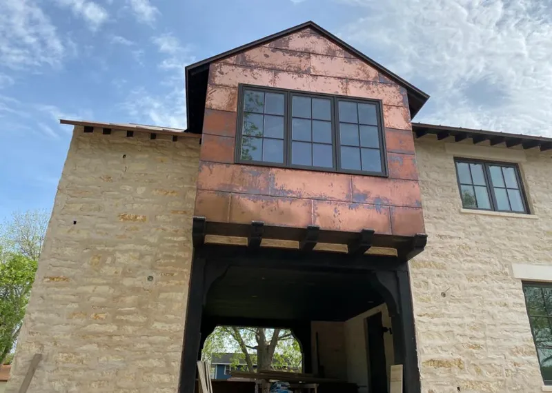 Copper metal panel facade on a stone building for Skylight Installation in Floyds Knobs